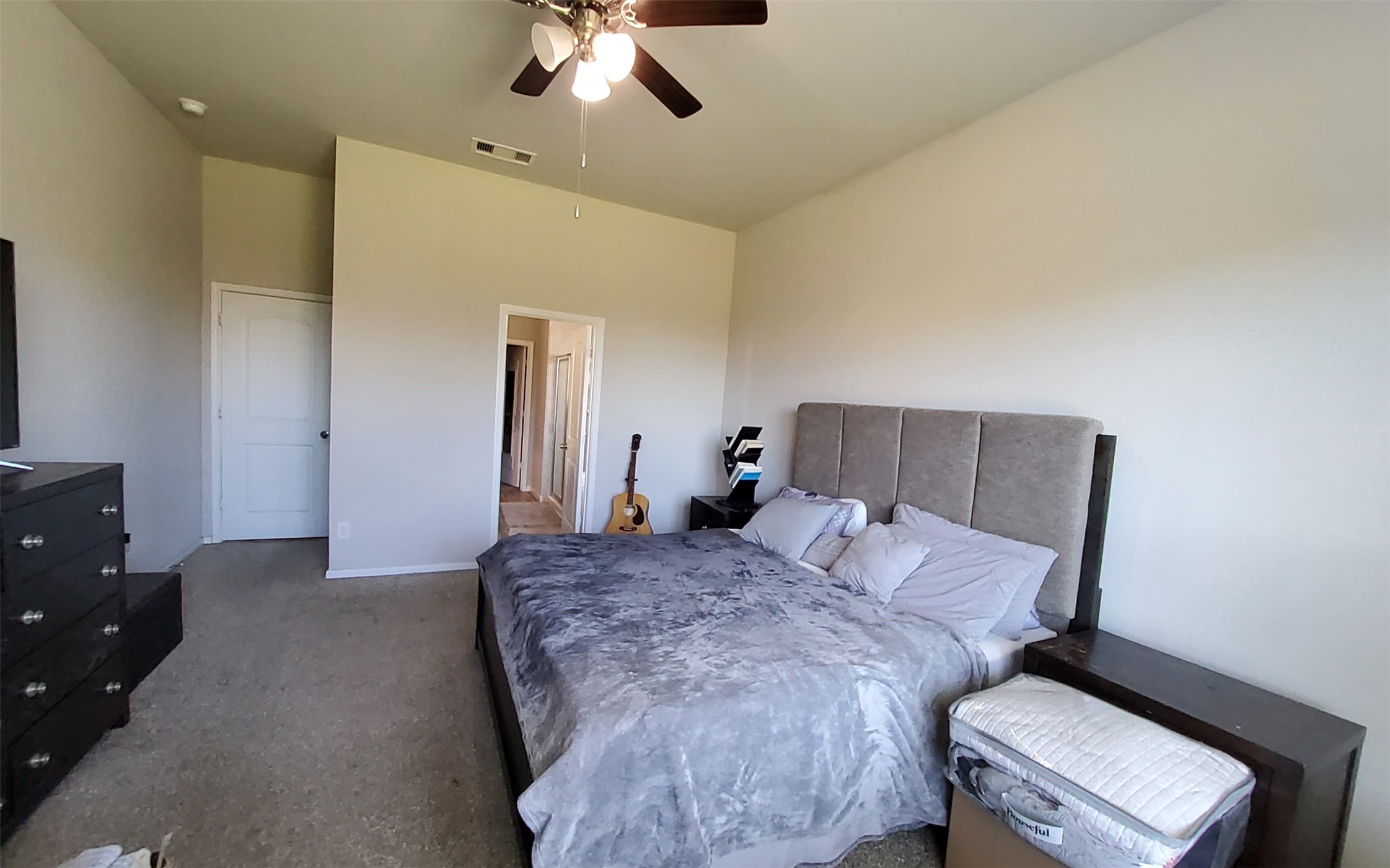 24418 Hollow Gate Meadow Court Spring, TX 77389 - Photo 28 of 45 a bedroom with a bed and a chandelier