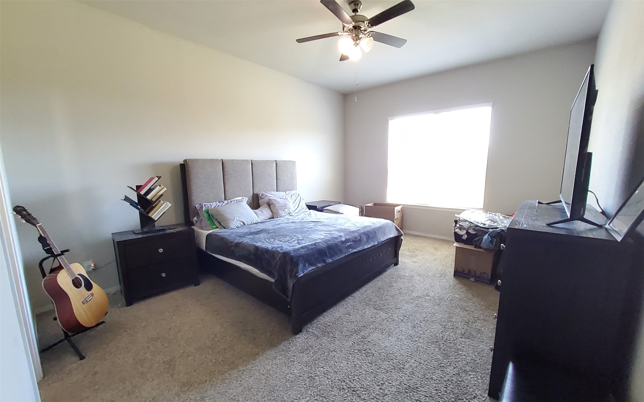 24418 Hollow Gate Meadow Court Spring, TX 77389 - Photo 29 of 45 a bedroom with a bed and a chandelier