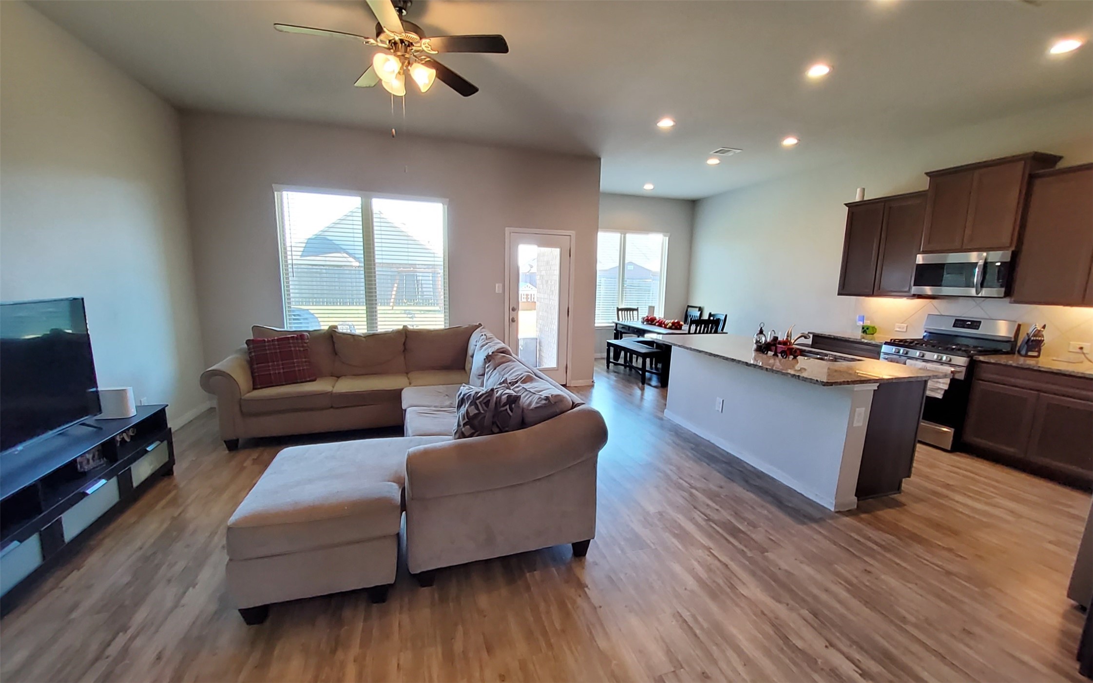 24418 Hollow Gate Meadow Court Spring, TX 77389 - Photo 10 of 45 a living room with furniture kitchen and a wooden floor