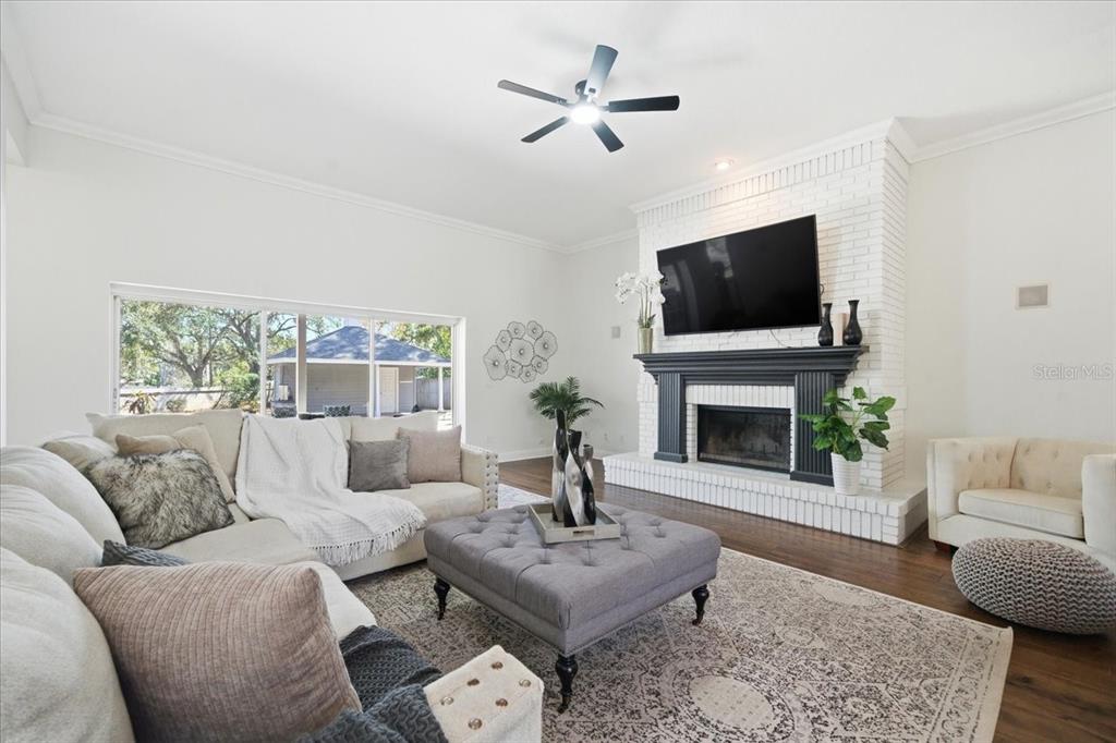 3049 Geiger Court Clearwater, FL 33761 - Photo 24 of 90 a living room with furniture a fireplace and a flat screen tv