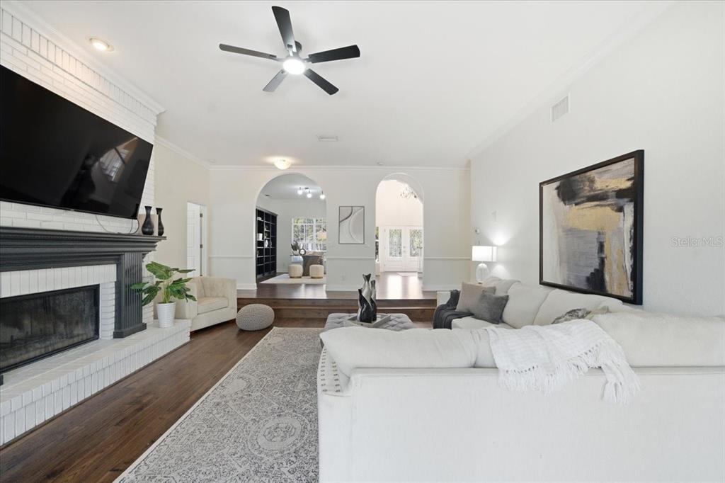 3049 Geiger Court Clearwater, FL 33761 - Photo 27 of 90 a living room with furniture a fireplace and a flat screen tv