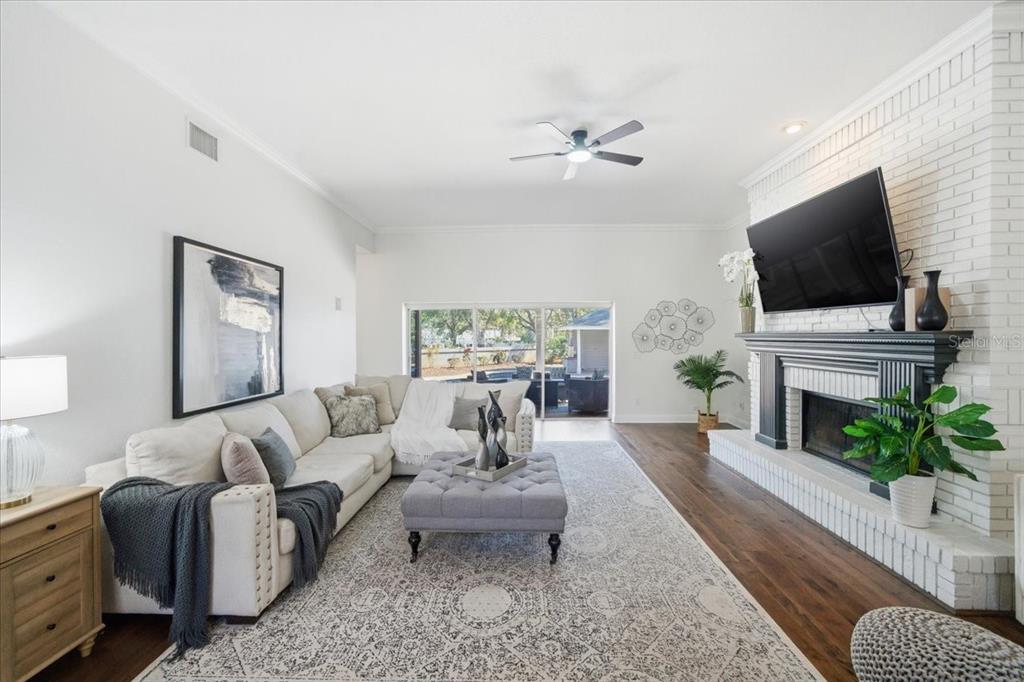 3049 Geiger Court Clearwater, FL 33761 - Photo 28 of 90 a living room with furniture a fireplace and a flat screen tv