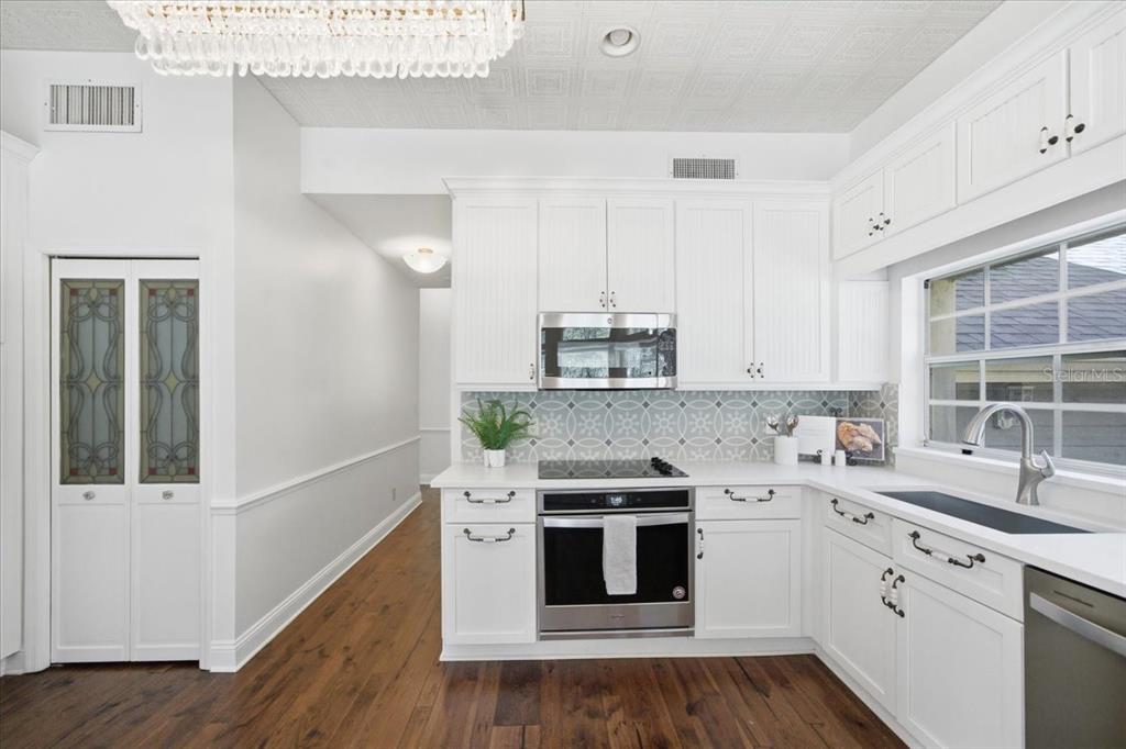 3049 Geiger Court Clearwater, FL 33761 - Photo 34 of 90 a kitchen with stainless steel appliances a white stove top oven sink and cabinets
