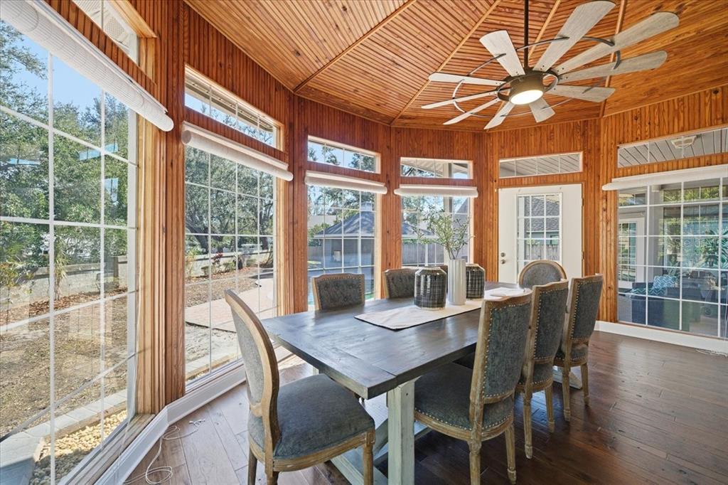 3049 Geiger Court Clearwater, FL 33761 - Photo 38 of 90 a view of a dining room with furniture large windows and wooden floor