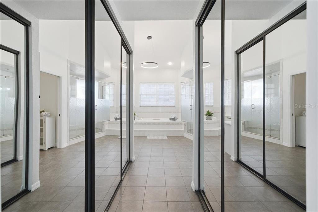 3049 Geiger Court Clearwater, FL 33761 - Photo 47 of 90 a bathroom with a glass shower door and a glass door