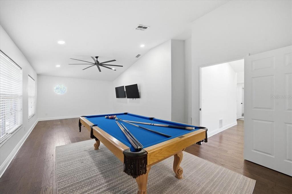 3049 Geiger Court Clearwater, FL 33761 - Photo 55 of 90 a room with wooden floor pool table and windows
