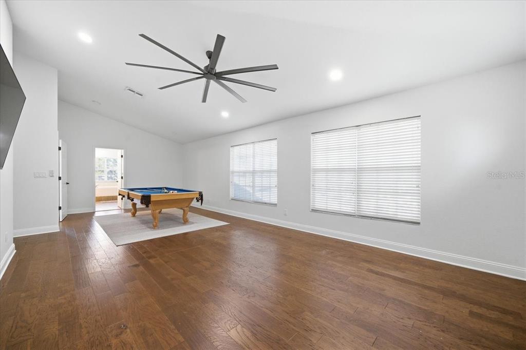 3049 Geiger Court Clearwater, FL 33761 - Photo 57 of 90 a view of a livingroom with wooden floor and a ceiling fan