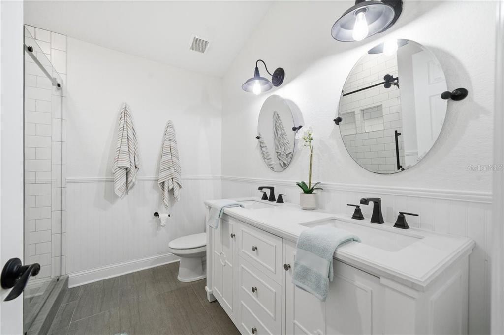 3049 Geiger Court Clearwater, FL 33761 - Photo 69 of 90 a bathroom with a double vanity sink mirror and toilet