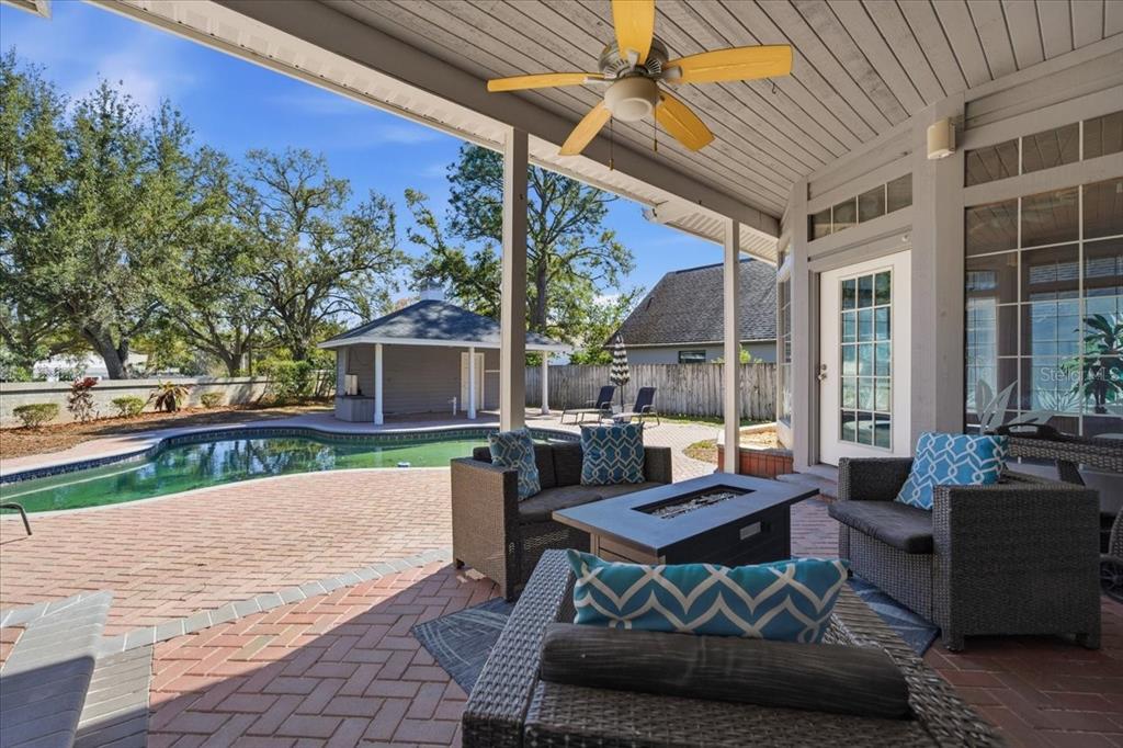 3049 Geiger Court Clearwater, FL 33761 - Photo 72 of 90 a view of a patio with couches and table and chairs with wooden floor and fence