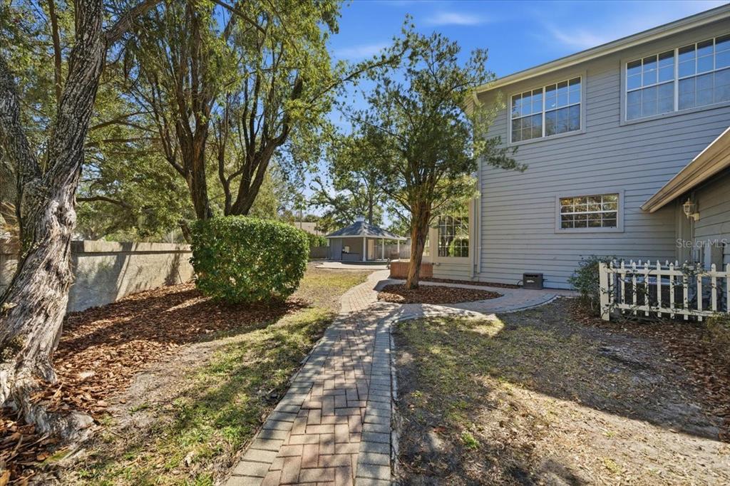3049 Geiger Court Clearwater, FL 33761 - Photo 79 of 90 a view of a backyard with plants and large trees
