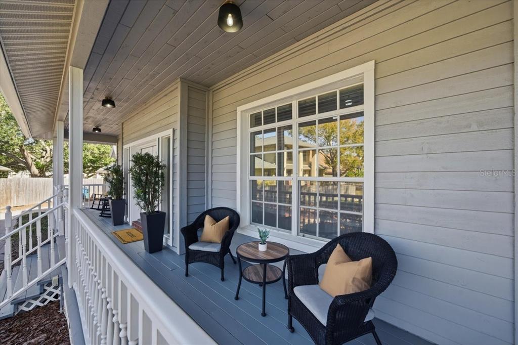 3049 Geiger Court Clearwater, FL 33761 - Photo 9 of 90 a balcony with chairs and wooden floor