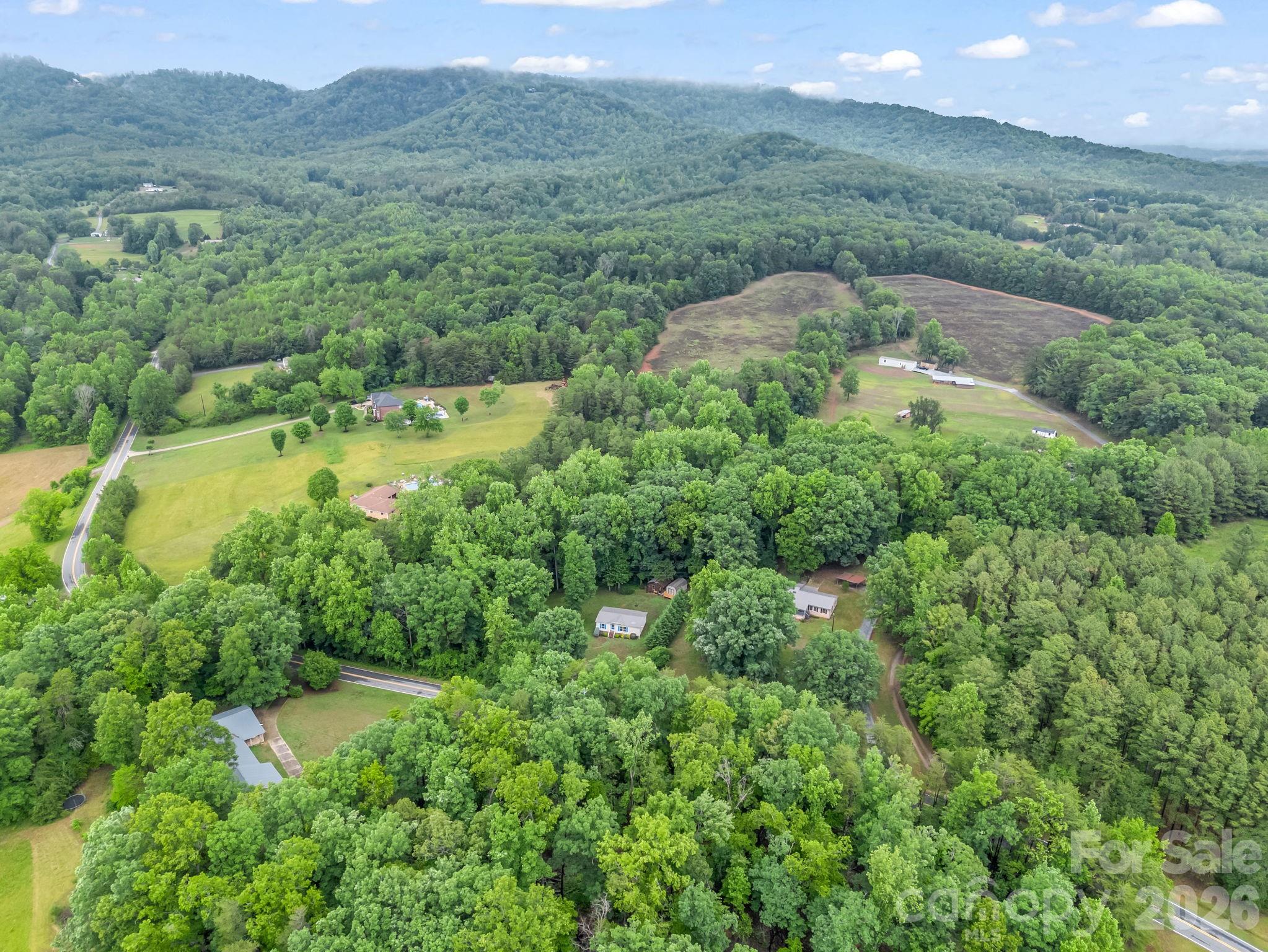 1449 Toney Road Bostic, NC 28018 - Photo 40 of 43 a view of a lush green hillside and a building