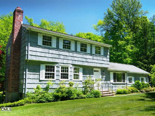 98 Pin Pack Road Ridgefield, CT 06877 - Photo 1 of 1 a front view of a house with garden and porch
