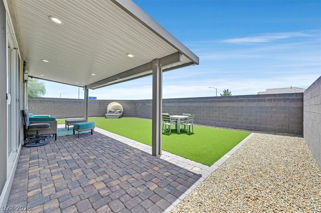2933 Little Current Road North Las Vegas, NV 89086 - Photo 31 of 35 A private outdoor space features a covered patio with recessed lighting and low-maintenance landscaping.