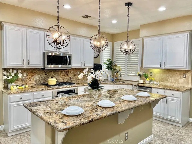 a bathroom with a granite countertop toilet and a sink