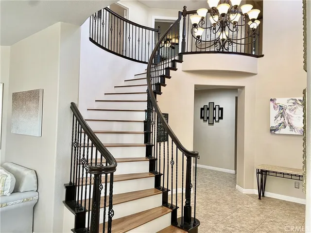 a view of a hallway with wooden floor and closet