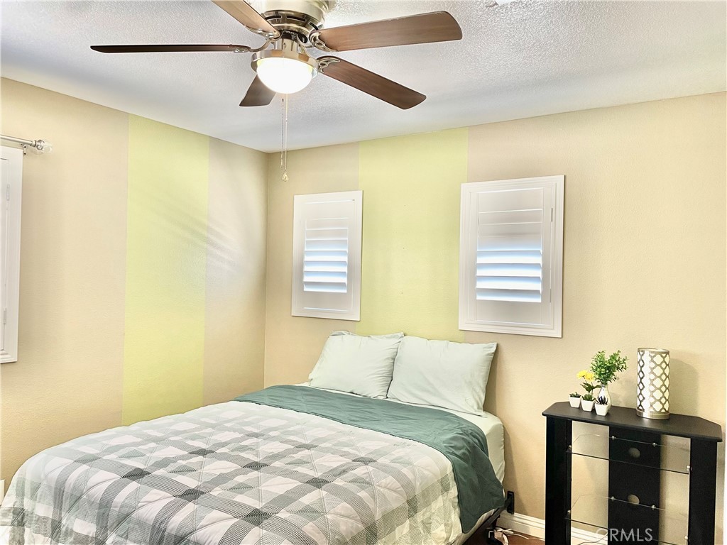 8004 Palm View Lane Riverside, CA 92508 - Photo 44 of 60 a bedroom with a bed and a chandelier