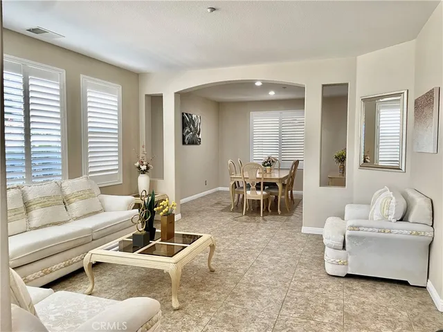 a living room with furniture and large windows