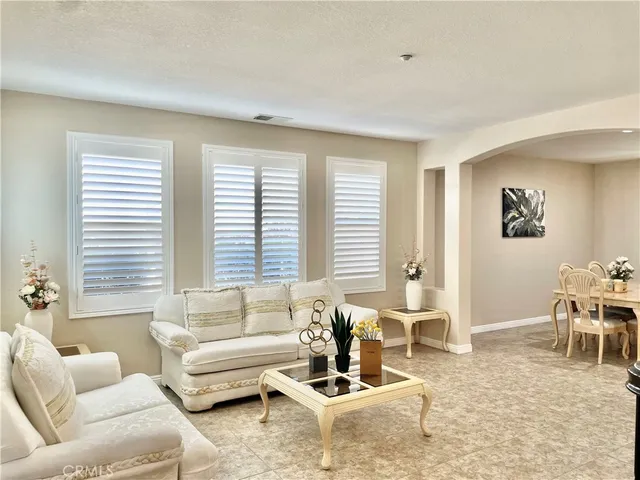 a kitchen with kitchen island granite countertop stove and white cabinets
