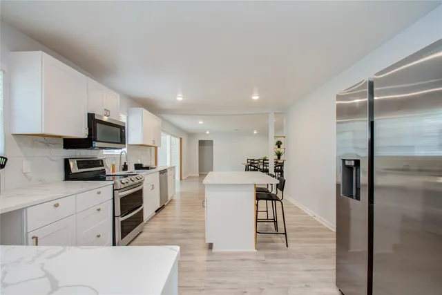 a kitchen with cabinets and stainless steel appliances