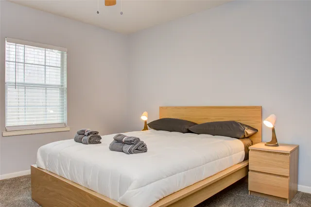 a bedroom with a bed and window