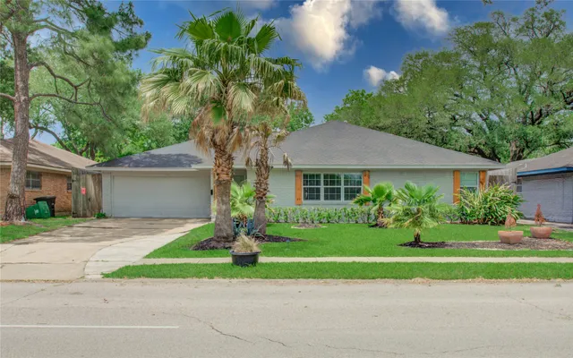 a front view of a house with a yard and a garage