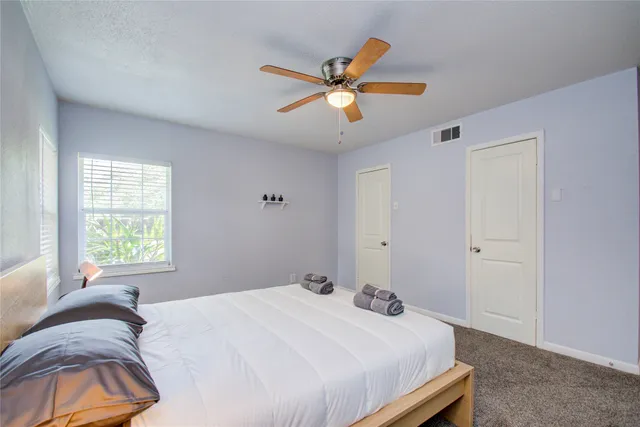 a bedroom with a bed and window