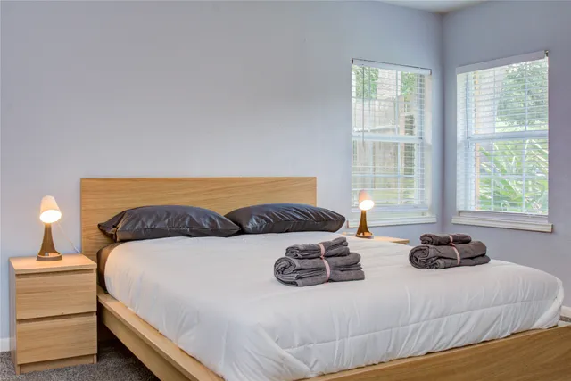 a bedroom with a bed and a window