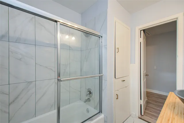 a bathroom with a glass shower door
