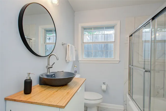 a view of a bathroom with a sink and mirror