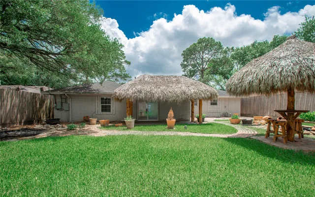 a backyard of a house with table and chairs