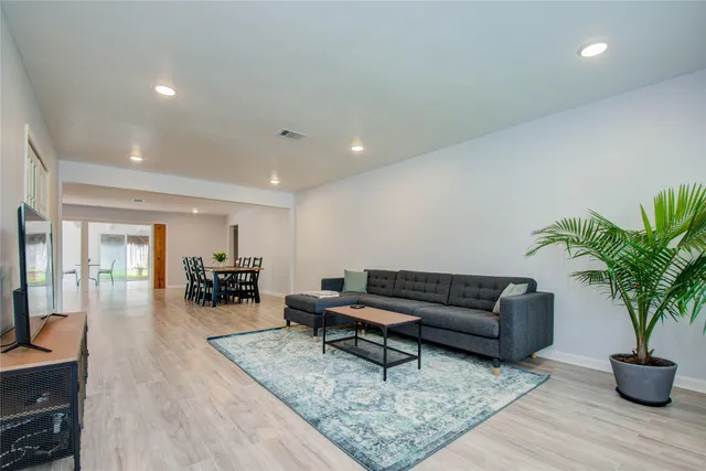 a living room with furniture and a potted plant
