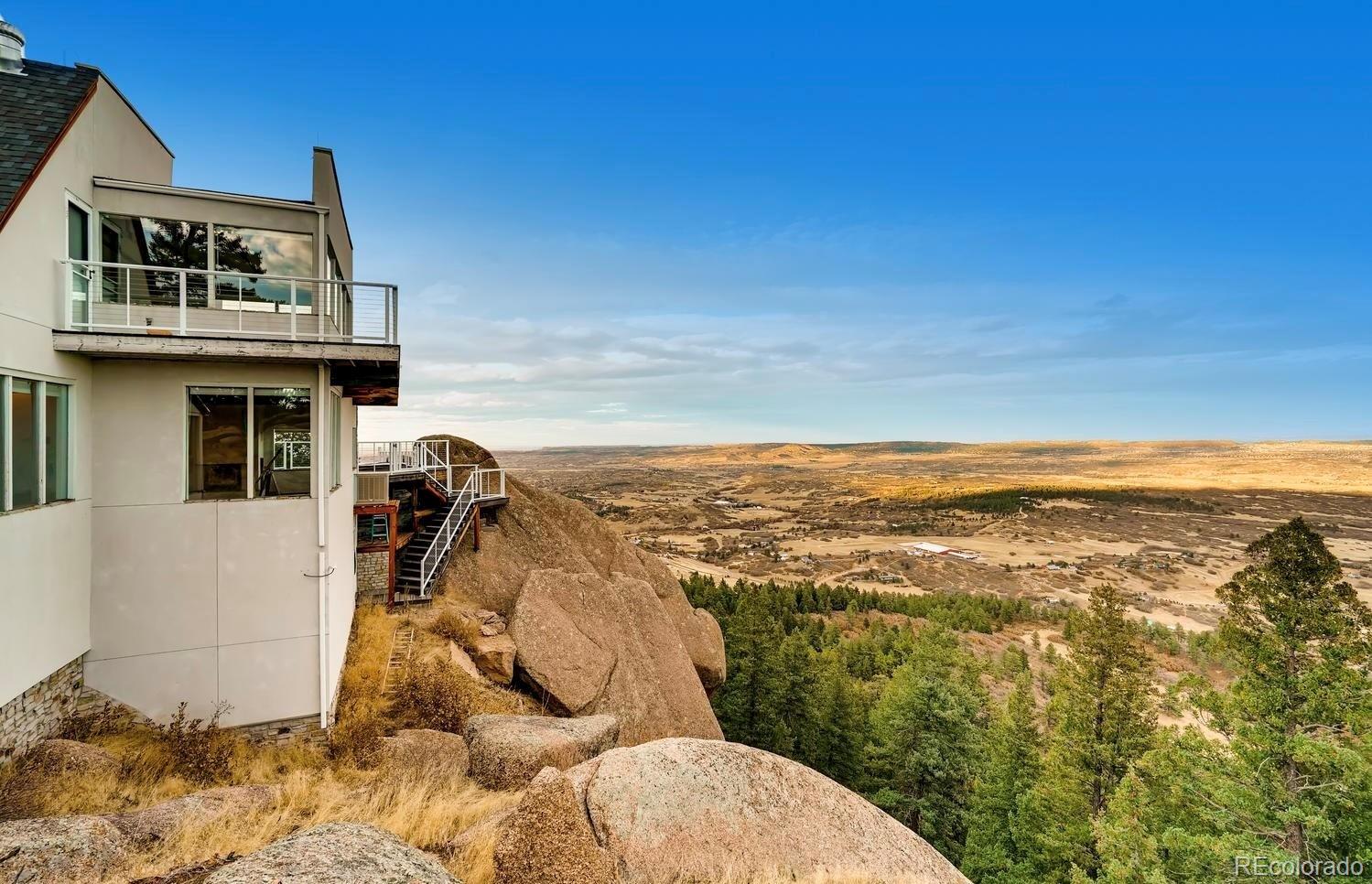 1150 North Madge Gulch Road Sedalia, CO 80135 - Photo 12 of 49 a view of a house with wooden floor and a floor to ceiling window