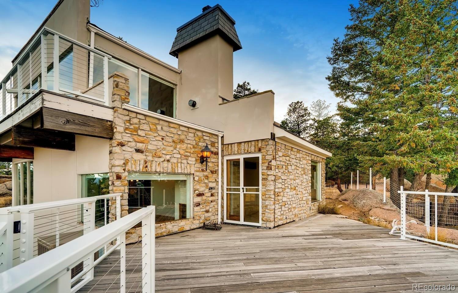 1150 North Madge Gulch Road Sedalia, CO 80135 - Photo 13 of 49 a view of a house with a flat screen tv