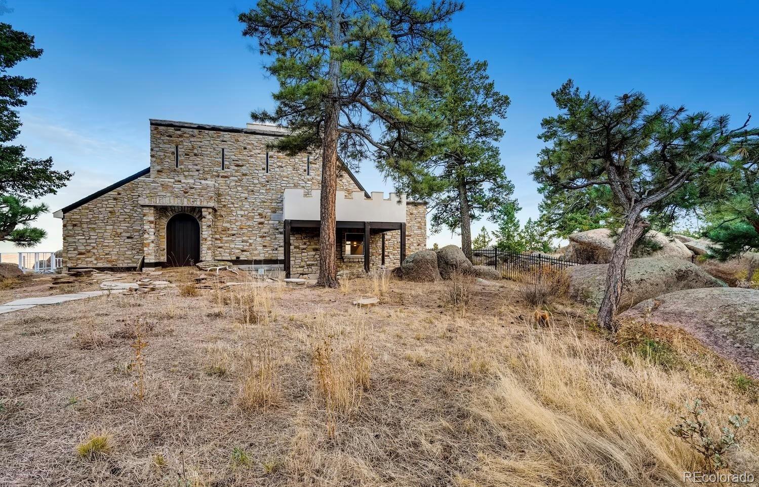 1150 North Madge Gulch Road Sedalia, CO 80135 - Photo 14 of 49 a view of a house with a yard and tree s
