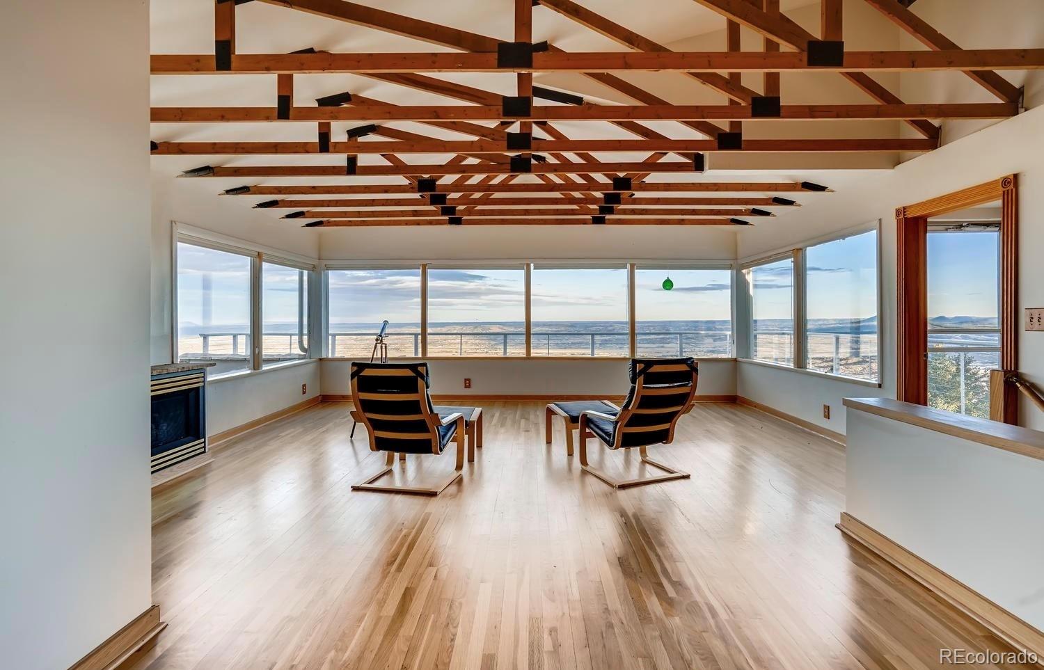 1150 North Madge Gulch Road Sedalia, CO 80135 - Photo 15 of 49 a view of a kitchen with wooden floor and furniture