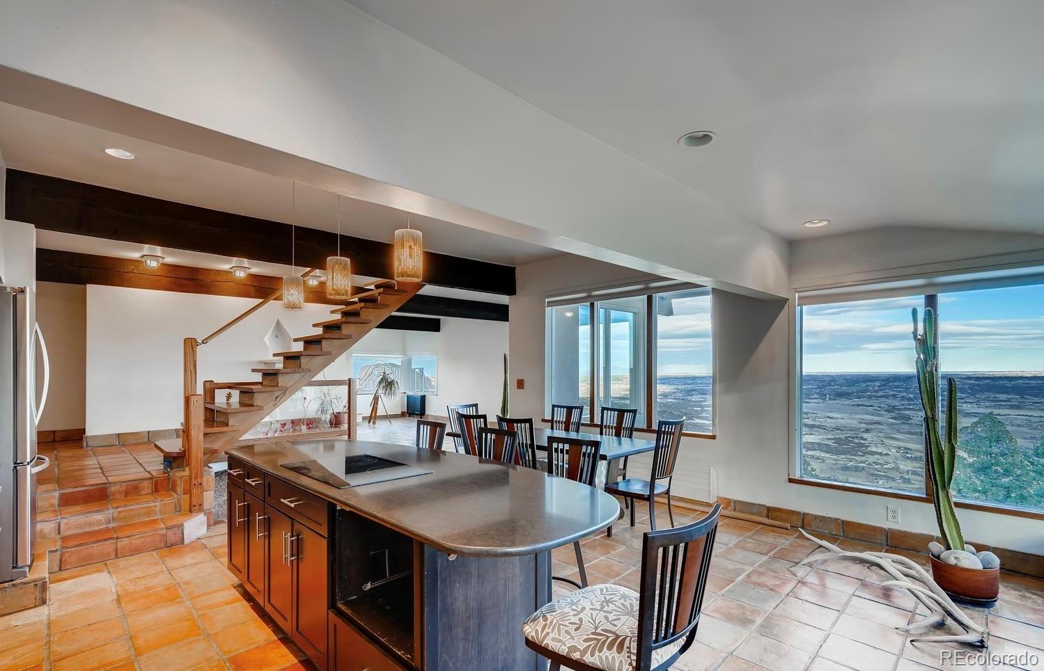 1150 North Madge Gulch Road Sedalia, CO 80135 - Photo 23 of 49 a kitchen with stainless steel appliances granite countertop a sink a stove and a wooden floors