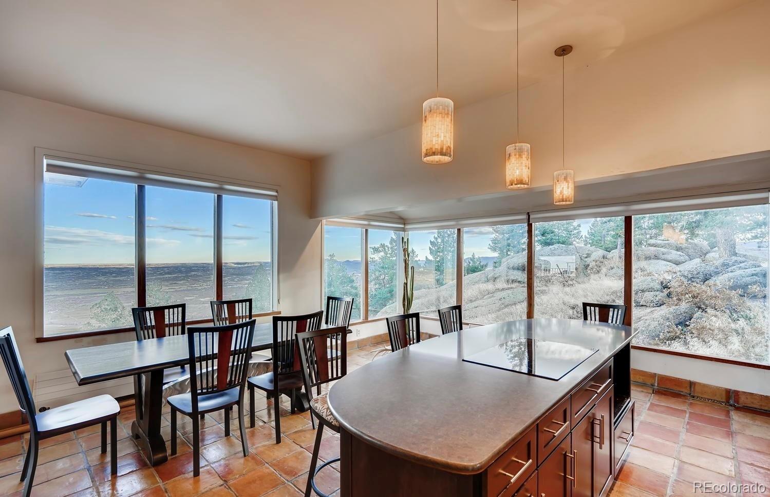 1150 North Madge Gulch Road Sedalia, CO 80135 - Photo 24 of 49 a dining room with furniture a chandelier and wooden floor
