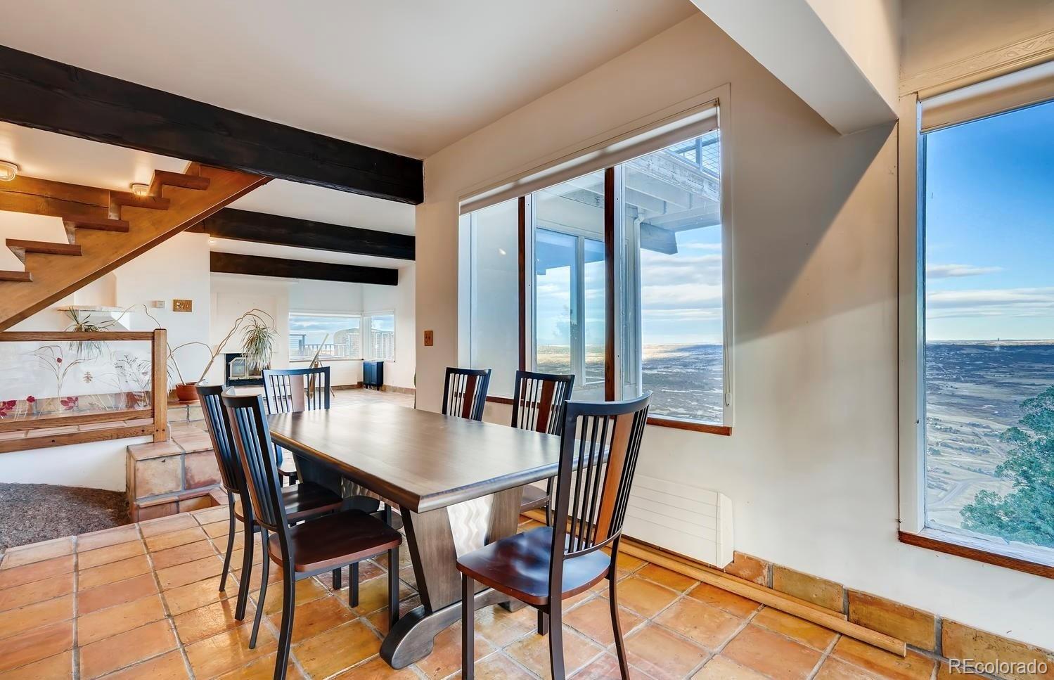 1150 North Madge Gulch Road Sedalia, CO 80135 - Photo 27 of 49 a view of a dining room with furniture and a window