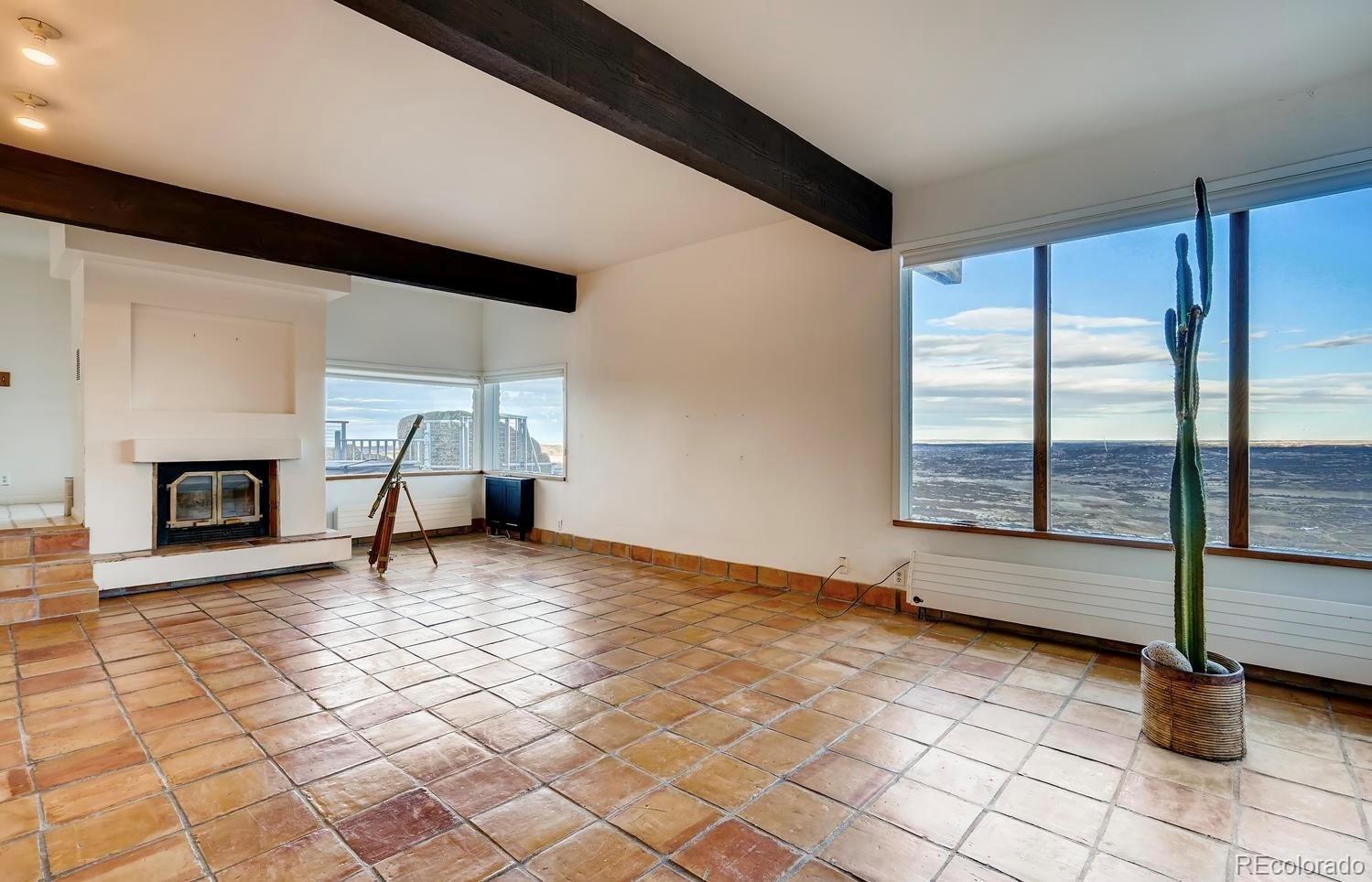 1150 North Madge Gulch Road Sedalia, CO 80135 - Photo 29 of 49 a view of empty room with fireplace