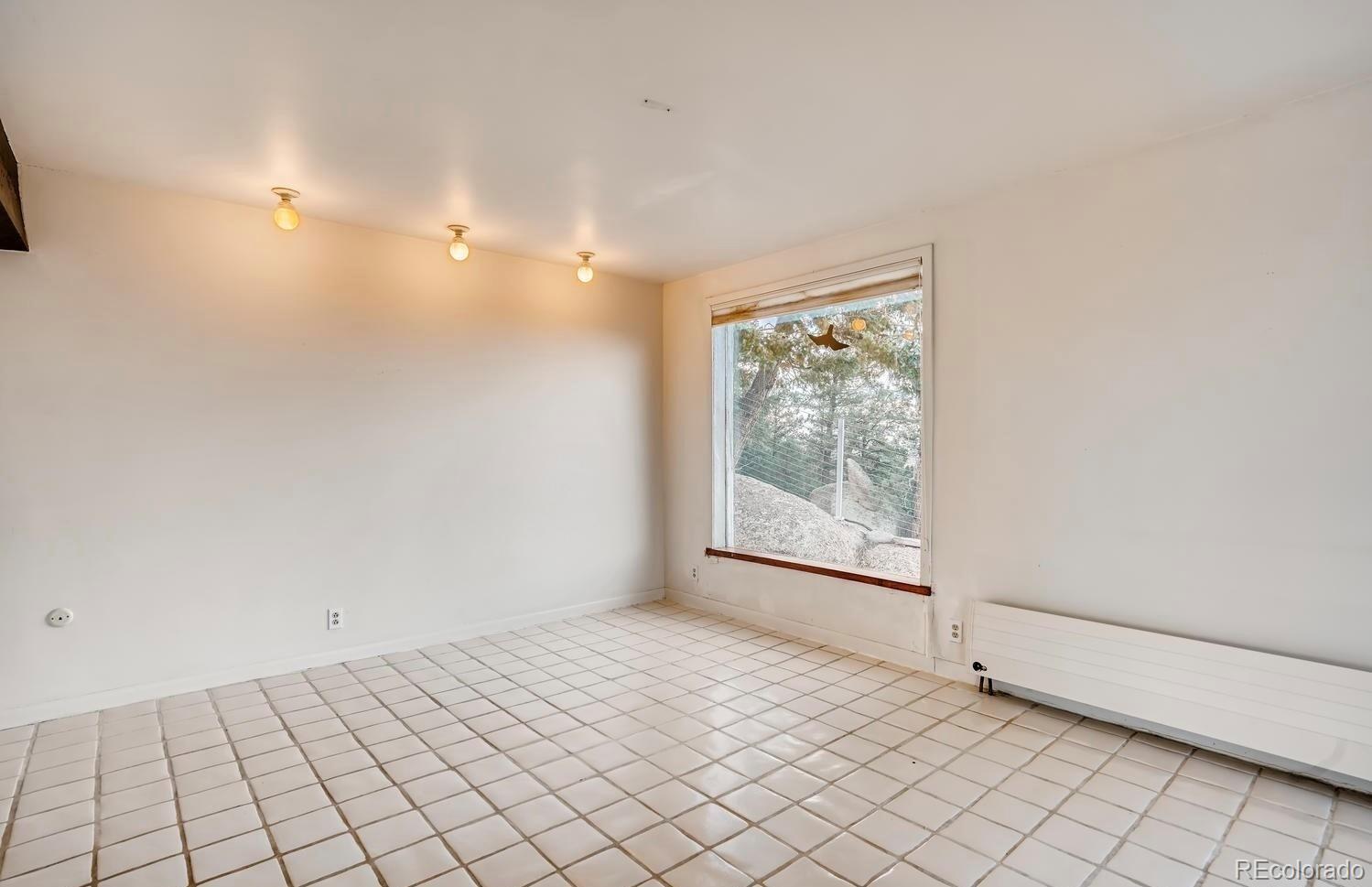 1150 North Madge Gulch Road Sedalia, CO 80135 - Photo 30 of 49 a view of an empty room and window