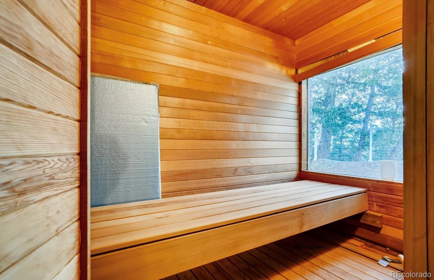 1150 North Madge Gulch Road Sedalia, CO 80135 - Photo 32 of 49 a view of a balcony with floor to ceiling windows with wooden floor