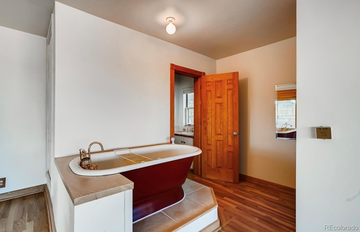 1150 North Madge Gulch Road Sedalia, CO 80135 - Photo 35 of 49 a room that has a sink and a wooden floor