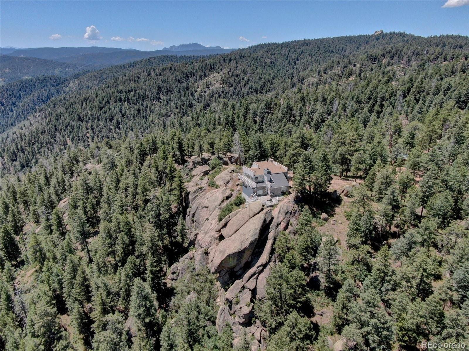 1150 North Madge Gulch Road Sedalia, CO 80135 - Photo 41 of 49 a view of a yard with a mountain
