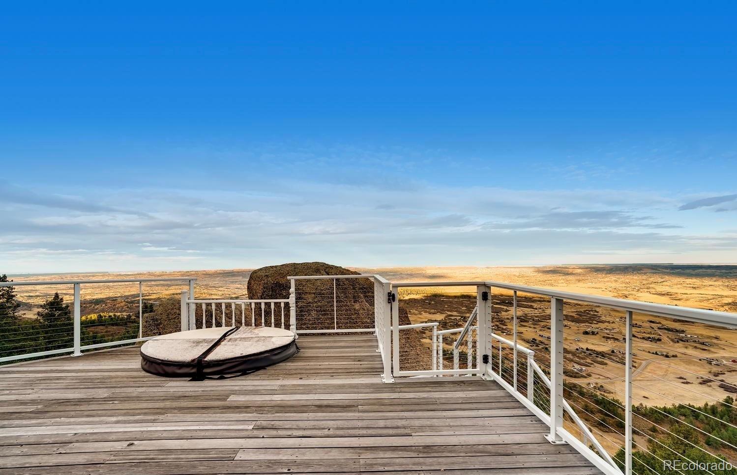 1150 North Madge Gulch Road Sedalia, CO 80135 - Photo 9 of 49 a view of a ocean from a balcony