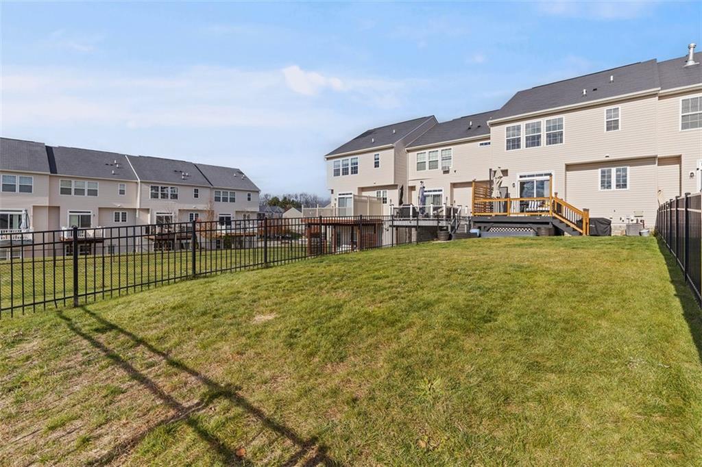 44 Coolidge Drive McKees Rocks, PA 15136 - Photo 5 of 36 a view of a white house with a big yard and large trees