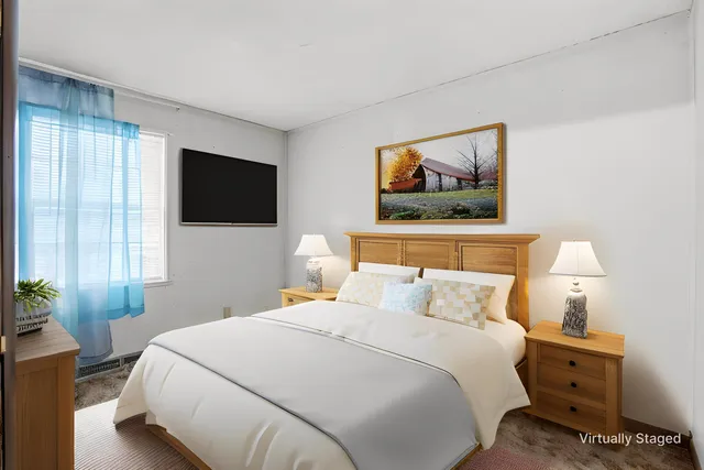 a bedroom with a bed and a flat screen tv