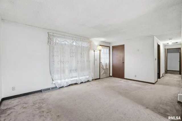 a view of an empty room with a glass door