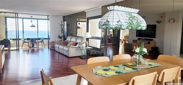 a living room with fireplace furniture and a large window