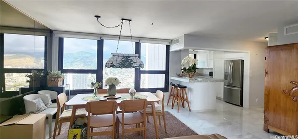 a kitchen with a stove and a view of living room